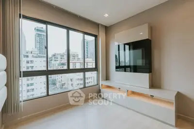 Modern living room with large window and sleek entertainment unit in urban apartment