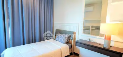 Cozy bedroom with modern decor and ample natural light, featuring a comfortable bed and stylish furnishings.