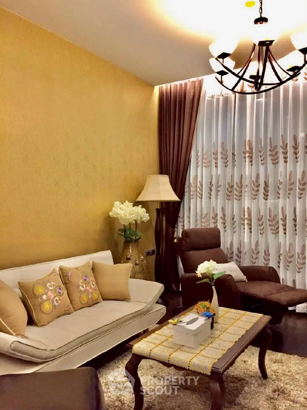 Elegant living room with plush seating, stylish decor, and warm lighting for a cozy ambiance.