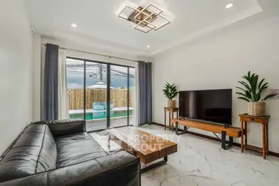 Modern living room with pool view, sleek furniture, and stylish lighting.