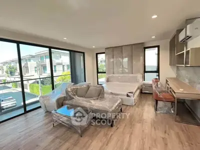 Spacious modern living room with large windows and stylish furniture in a contemporary home.