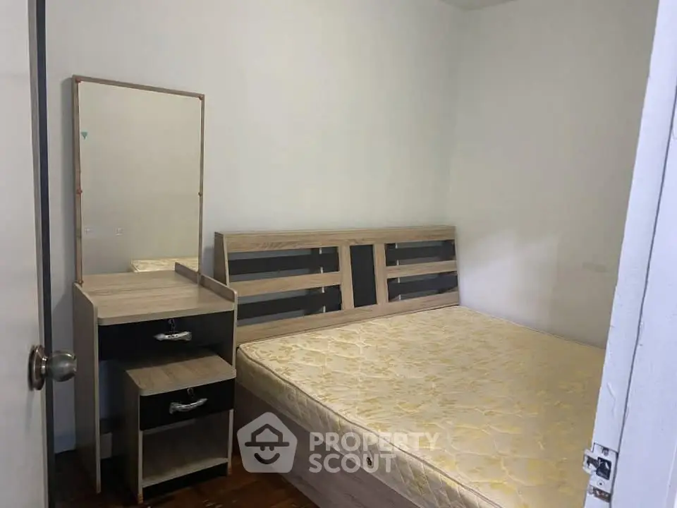 Cozy bedroom with wooden furniture and a comfortable bed, perfect for restful nights.