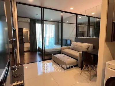 Modern studio apartment with glass partition, cozy living area, and natural light.