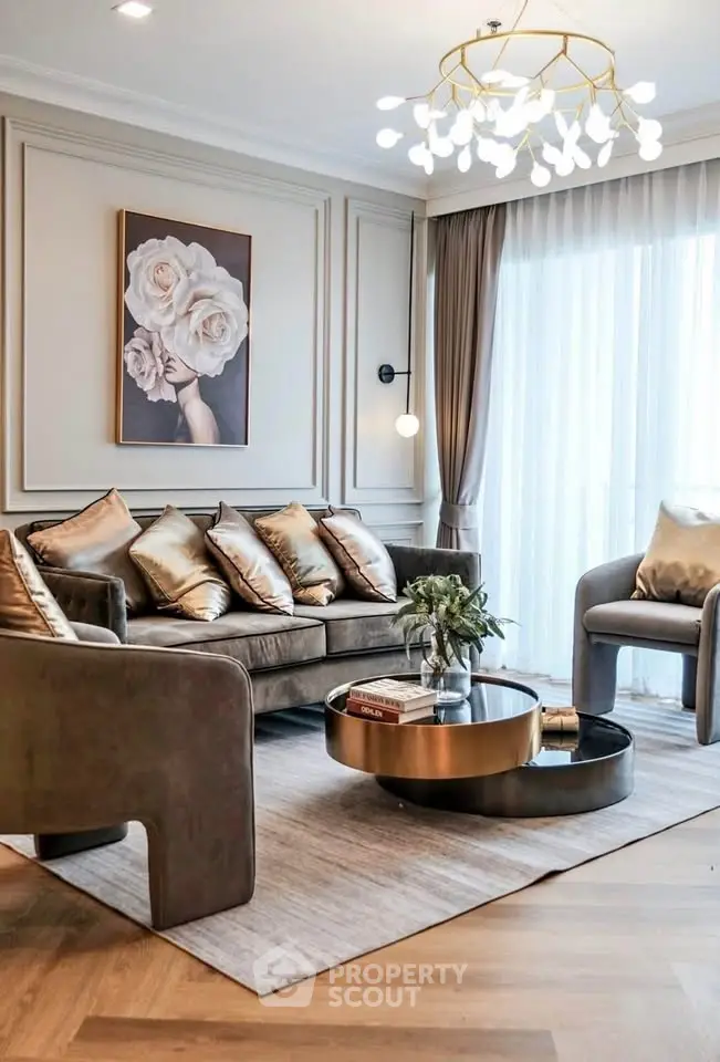 Luxurious living room with elegant decor and modern chandelier, featuring plush seating and stylish artwork.