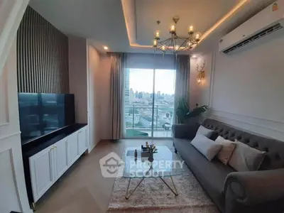 Luxurious living room with city view, elegant chandelier, and modern decor.