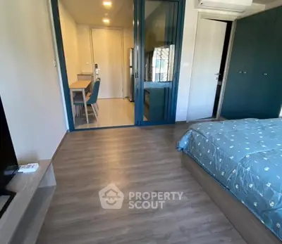 Modern bedroom with stylish decor and view into adjacent room