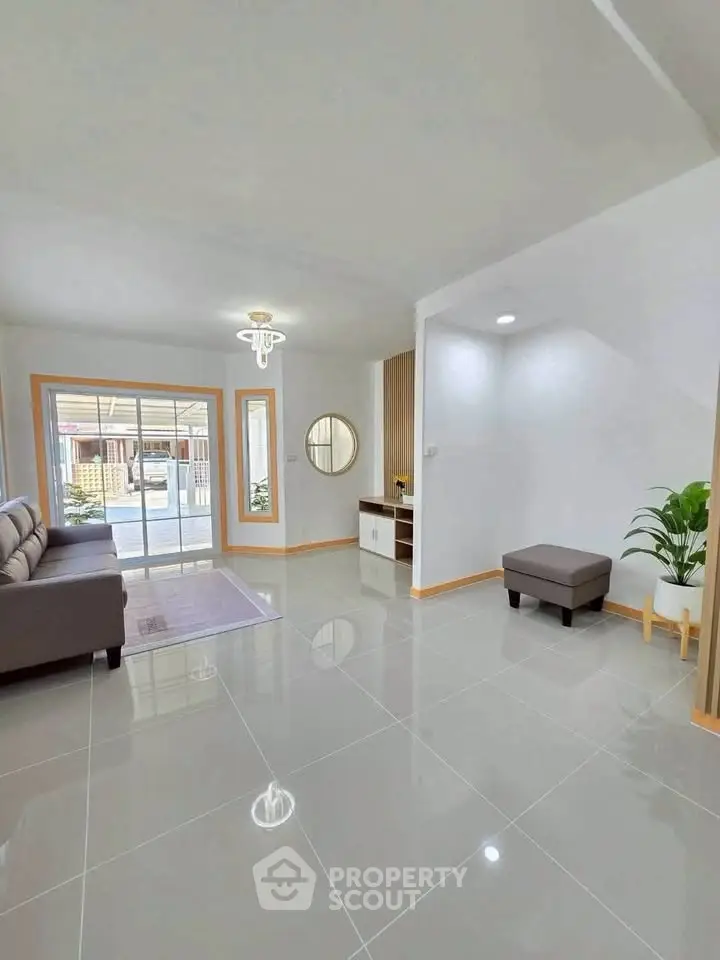 Spacious modern living room with sleek tile flooring and stylish decor