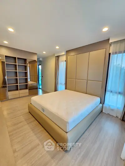 Spacious modern bedroom with elegant design and ample natural light