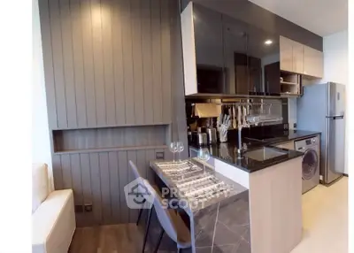 Modern kitchen with sleek design, featuring built-in appliances and stylish dining area.