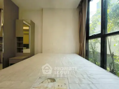 Bright bedroom with large window and modern furniture, perfect for natural light lovers.