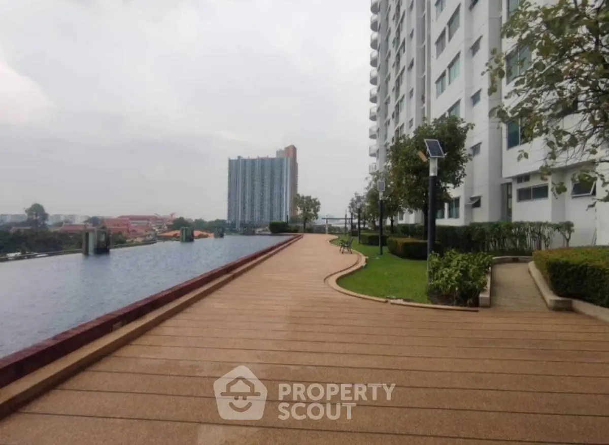 Modern apartment building with scenic rooftop garden and pool view.