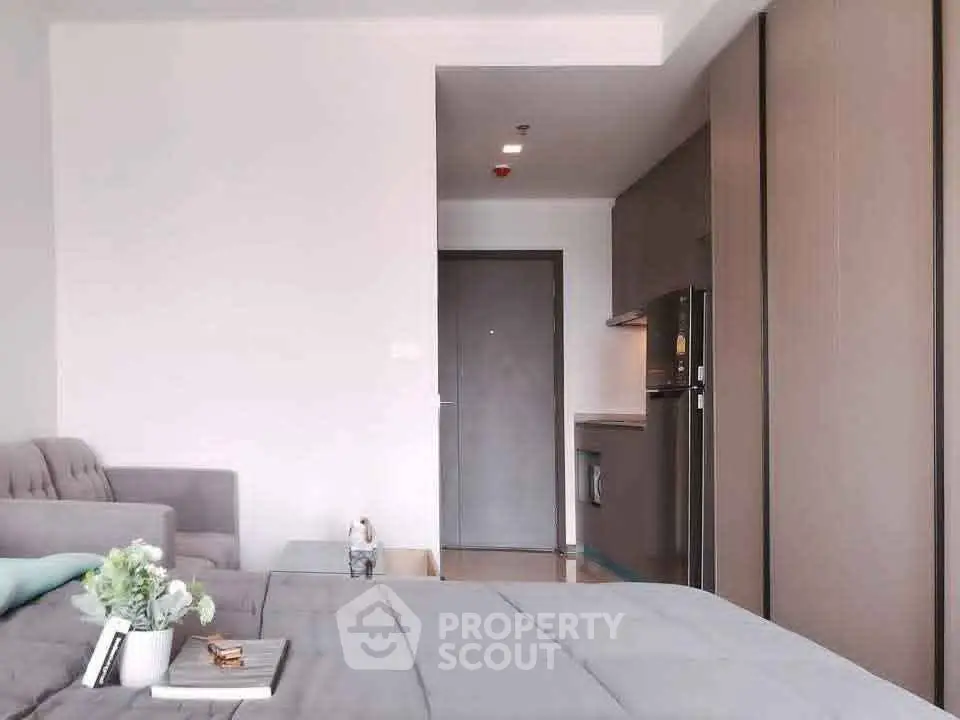 Modern studio apartment with cozy living area and sleek kitchen design.