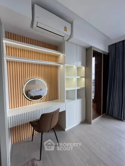 Modern study area with built-in desk, shelves, and air conditioning in a stylish apartment.