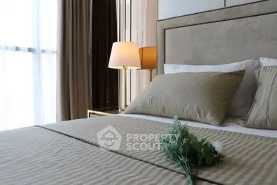 Luxurious bedroom with elegant decor and soft lighting, featuring a plush bed and stylish bedside lamp.