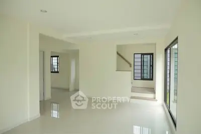 Spacious modern living room with large windows and minimalist design