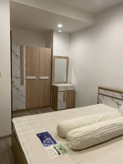 Modern bedroom with stylish wardrobe and cozy bed in a contemporary apartment.