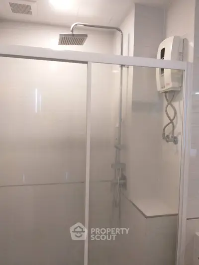 Modern bathroom with glass shower enclosure and water heater
