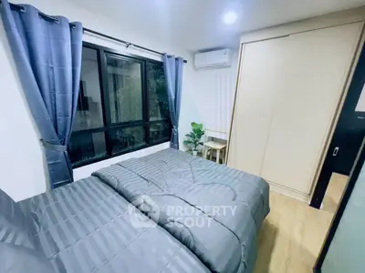 Modern bedroom with large window, stylish curtains, and sleek wooden wardrobe