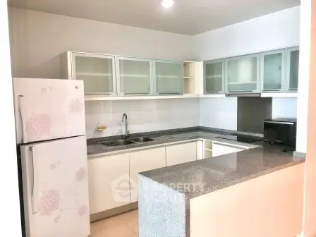 Modern kitchen with sleek cabinets and granite countertops in a stylish apartment.