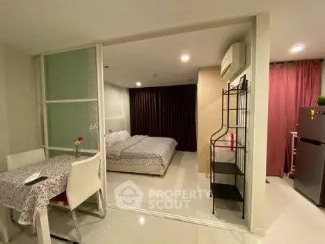Cozy studio apartment with modern decor and dining area