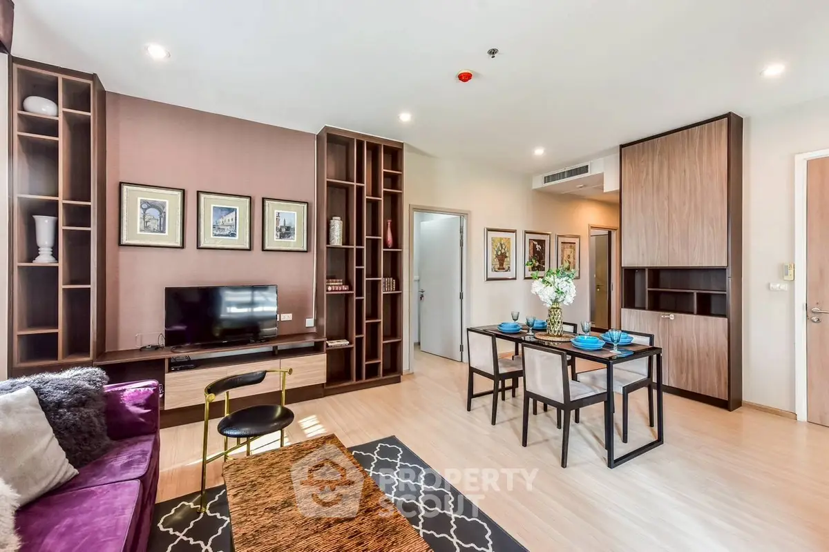 Modern living room with stylish decor and dining area in open layout apartment.