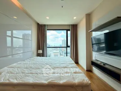 Modern bedroom with large window offering stunning city views, featuring sleek furniture and cozy ambiance.