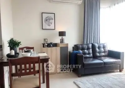 Cozy living room with leather sofa and dining area, perfect for modern living.