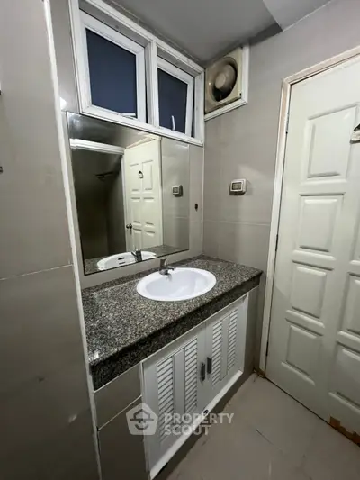 Modern bathroom with sleek granite countertop and stylish mirror