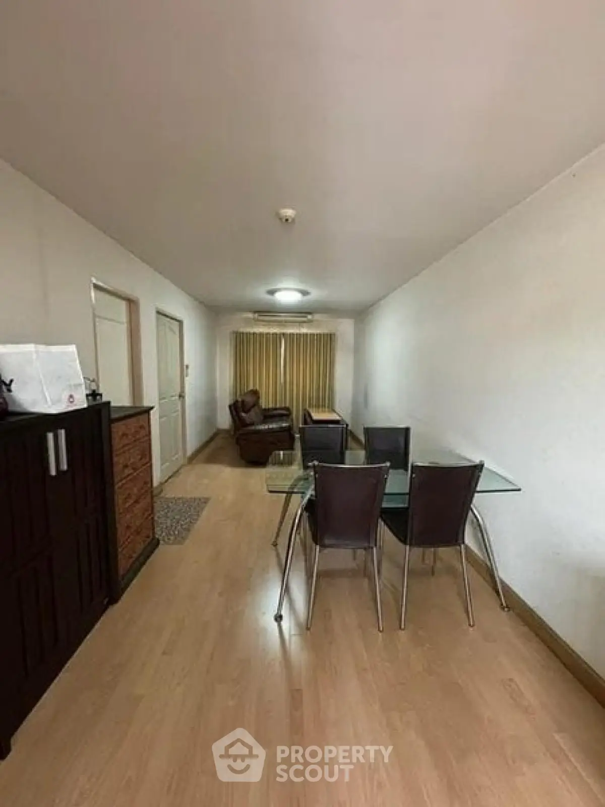 Spacious living room with modern dining set and cozy seating area, perfect for relaxation and entertaining.