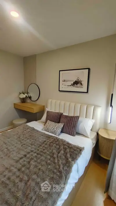 Cozy bedroom with elegant decor and soft lighting, featuring a plush bed and stylish furnishings.