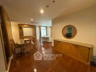 Spacious dining and living area with elegant wooden flooring and modern furniture.