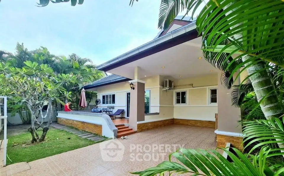 Charming tropical home with spacious patio and lush garden, perfect for outdoor living.