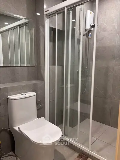 Modern bathroom with sleek shower and contemporary toilet design.