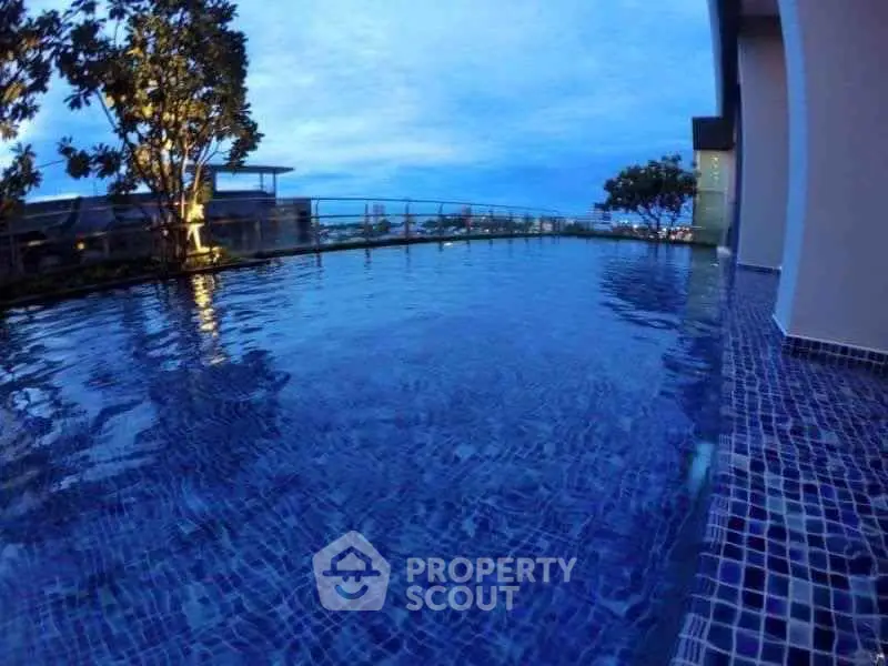 Luxurious rooftop pool with stunning city view at sunset