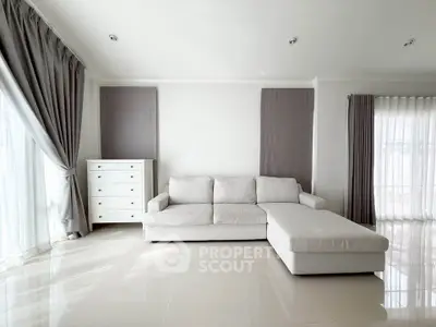 Spacious modern living room with elegant white sofa and natural light