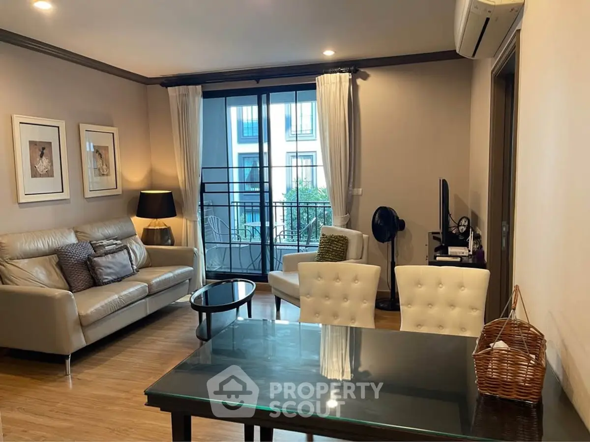 Stylish living room with modern decor and balcony view