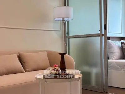 Cozy living room with beige sofa and elegant decor in modern apartment.