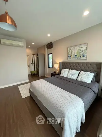 Spacious modern bedroom with elegant decor and cozy ambiance