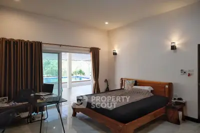 Spacious bedroom with pool view and modern decor