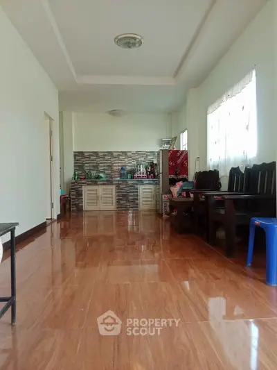 Spacious living room with wooden flooring and open kitchen layout