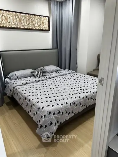 Cozy bedroom with modern decor and stylish bedding in a contemporary apartment.