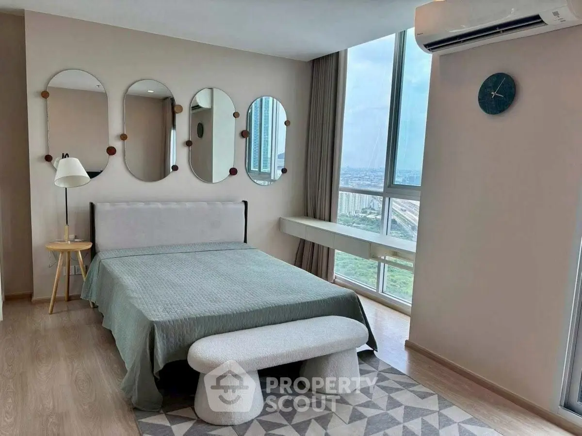 Modern bedroom with large windows and stylish decor in high-rise apartment.