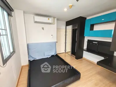 Modern bedroom with sleek black furniture and air conditioning