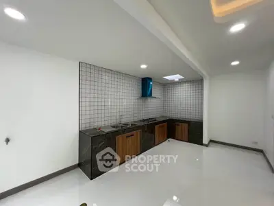 Modern kitchen with sleek design, featuring a gas stove and ample counter space, perfect for culinary enthusiasts.