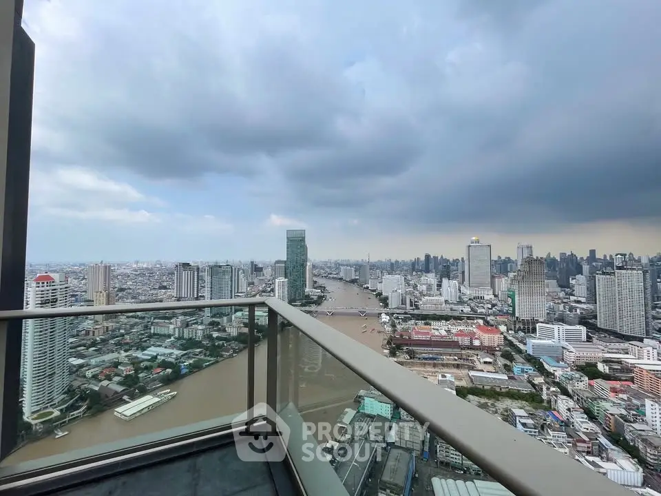 Stunning cityscape view from a high-rise balcony overlooking a river and skyline.
