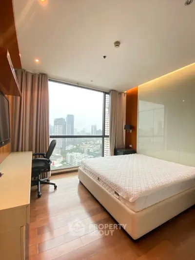 Luxurious bedroom with stunning city view and modern furnishings