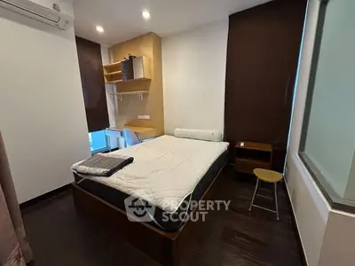 Cozy bedroom with modern furnishings and ample natural light, perfect for restful nights.