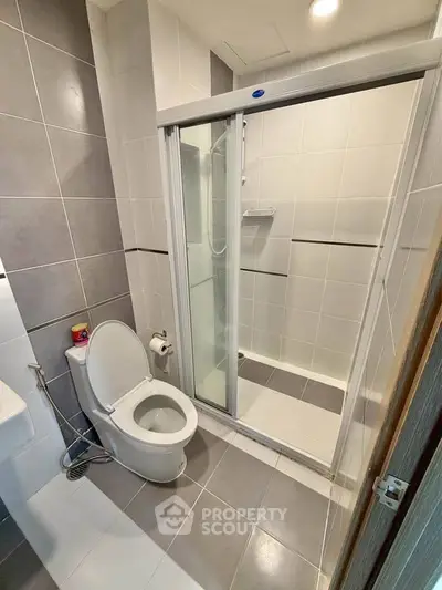 Modern bathroom with sleek shower and contemporary fixtures in stylish apartment.