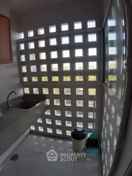 Modern kitchen with unique window design and sleek countertop