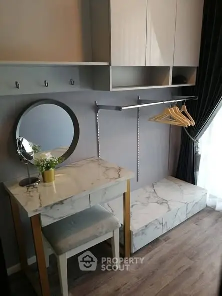 Stylish modern dressing area with marble accents and elegant storage solutions.